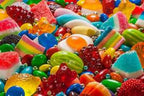 Assorted colorful candies including gummy bears and jelly beans.